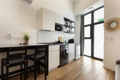 a kitchen with a counter and a washer and dryer at Urban loft Benicalap in Valencia