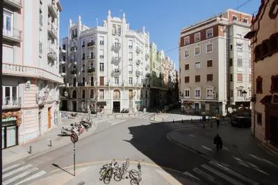 an empty street in a city with many buildings at Apartment Ruzafa Market 1D in Valencia