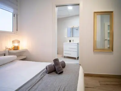 a bedroom with a white bed and a mirror at Apartment Ruzafa Market 6B in Valencia