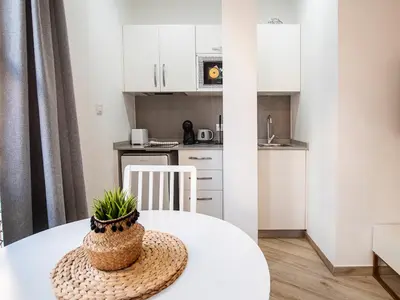 a small kitchen with a white table with a plant on it at Apartment Ruzafa Market 6B in Valencia