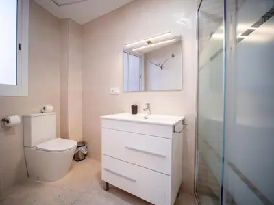 a bathroom with a toilet and a sink and a mirror at Apartment Ruzafa Market 6B in Valencia