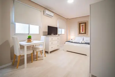 a small bedroom with a bed and a desk and a television at Apartment Ruzafa Market 6A in Valencia