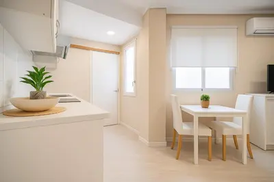 a kitchen with a table and a table and chairs at Apartment Ruzafa Market 6A in Valencia