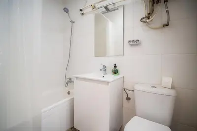 a white bathroom with a toilet and a sink at Apartment Ruzafa Market 6A in Valencia
