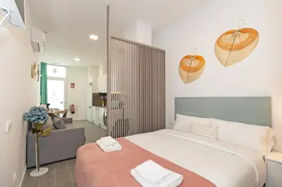 a bedroom with a large bed and a couch at GuestReady - Fontilles apartments in Valencia