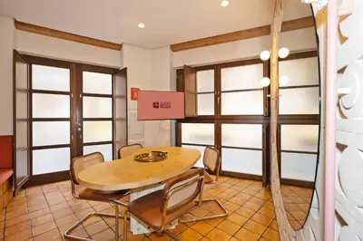 a table and chairs in a room with windows at GuestReady - Stay near the Central Market in Valencia