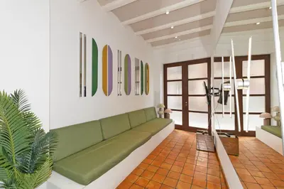 a living room with a green couch and some paintings at GuestReady - Stay near the Central Market in Valencia