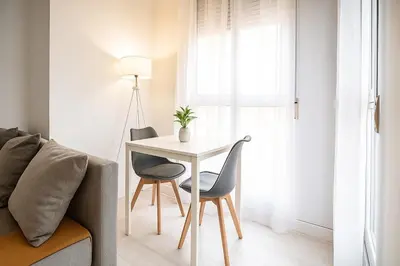 a table and chairs in a living room with a couch at Apartment Ruzafa Market 7B in Valencia