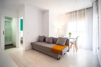 a living room with a couch and a table at Apartment Ruzafa Market 7B in Valencia