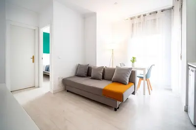 a living room with a couch and a table at Apartment Ruzafa Market 7B in Valencia