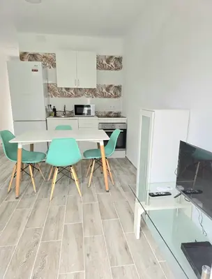 a kitchen with a table and some chairs and a counter at La Casita de Beni Valencia in Valencia