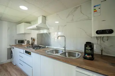 a white kitchen with a sink and a stove at ChillOut Area 2BR 4P City Relax Fast WiFi Pet Friendly in Valencia