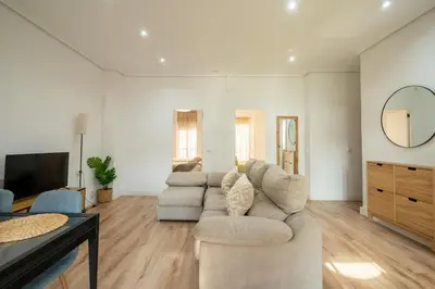 a living room with a couch and a tv at ChillOut Area 2BR 4P City Relax Fast WiFi Pet Friendly in Valencia