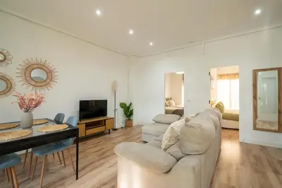 a living room with a couch and a table and a television at ChillOut Area 2BR 4P City Relax Fast WiFi Pet Friendly in Valencia