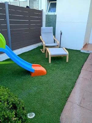a playground with a slide and a chair at Casa familiar 3 dormitorios Jardín Piscina Barbacoa Zona de entrenamiento in Bétera