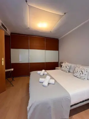 a bedroom with a large bed with towels on it at Casa familiar 3 dormitorios Jardín Piscina Barbacoa Zona de entrenamiento in Bétera