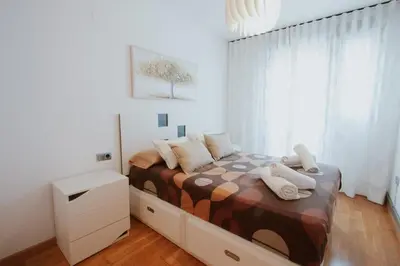 a bedroom with a bed with pillows on it at Family & Friends Apartment with Pool in Torrent