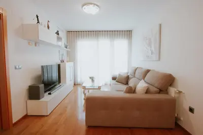 a living room with a couch and a television at Family & Friends Apartment with Pool in Torrent