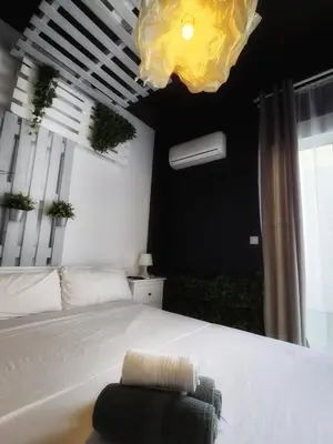 a bedroom with a white bed and a large window at Cozy Room G20 in Valencia