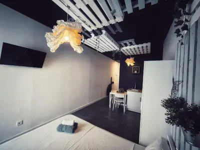 a room with a bed and a table and a chandelier at Cozy Room G20 in Valencia