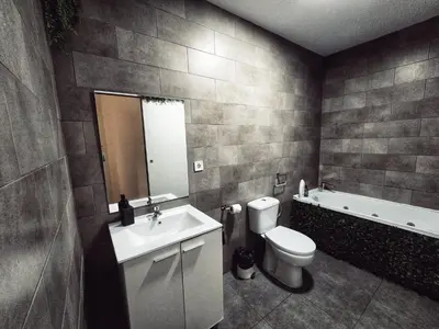 a bathroom with a sink and a toilet and a tub at Cozy Room G20 in Valencia