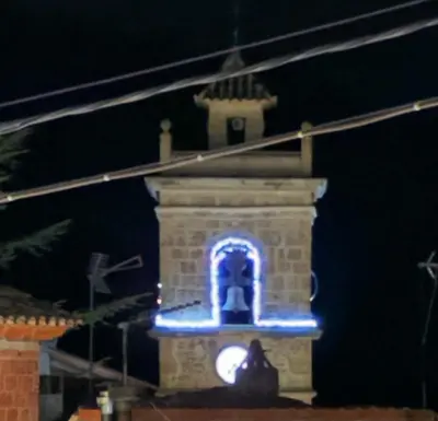 a clock tower with blue lights on it at night at Villa punta RJ in Pavías