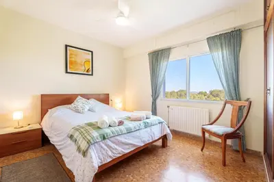 a bedroom with a bed and a chair and a window at Masia Miliuca Paraíso rural a un paso de Valencia - Rural paradise close to Valencia in Bétera