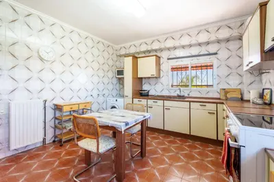 a kitchen with a table and chairs in a room at Masia Miliuca Paraíso rural a un paso de Valencia - Rural paradise close to Valencia in Bétera