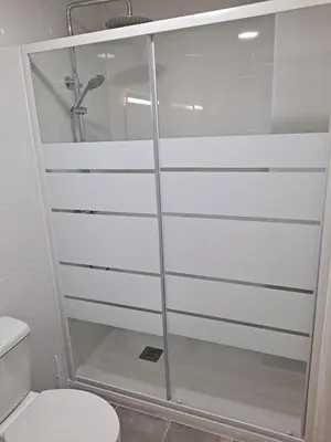 a shower stall in a bathroom with a toilet at Comfortable apartment in the Feria 2 area in Valencia