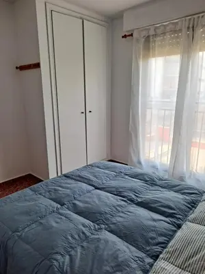 a bedroom with a bed and a window at Comfortable apartment in the Feria 2 area in Valencia