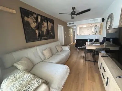 a living room with a white couch and a table at Canet al Mar Luxe y Confort-Pet Friendly in Canet de Berenguer