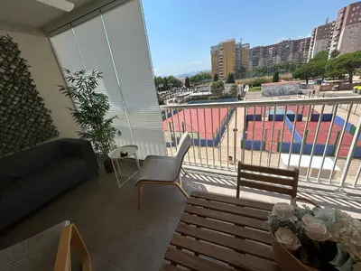 a room with a balcony with a couch and a bench at Canet al Mar Luxe y Confort-Pet Friendly in Canet de Berenguer