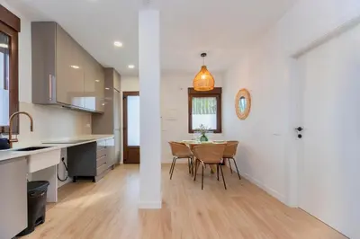a kitchen and dining room with a table and chairs at - Marés Cabanyal -Mediterráneo en clave boutique in Valencia
