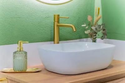 a bathroom sink with a faucet and a bottle of soap at - Marés Cabanyal -Mediterráneo en clave boutique in Valencia