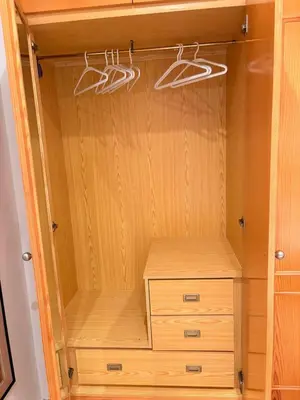 a closet with wooden cabinets and hangers at Apartamento en Primera Linea de Playa en Mareny de Barraquetes-Vistas al Mar-El Refugio del Mediterráneo in Mareny Barraquetas
