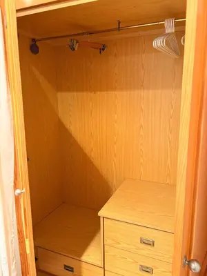 a closet with a wooden cabinet and a dresser at Apartamento en Primera Linea de Playa en Mareny de Barraquetes-Vistas al Mar-El Refugio del Mediterráneo in Mareny Barraquetas