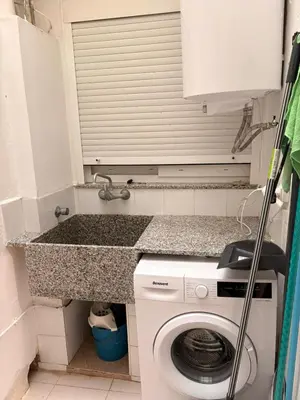a washing machine in a small kitchen with a counter at Apartamento en Primera Linea de Playa en Mareny de Barraquetes-Vistas al Mar-El Refugio del Mediterráneo in Mareny Barraquetas