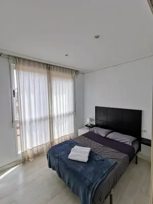 a bedroom with a bed and a large window at Apartment Ruzafa Market 7C in Valencia