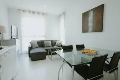 a white living room with a glass table and chairs at Apartment Ruzafa Market 7D in Valencia