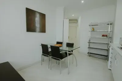 a dining room with a table and chairs in a kitchen at Apartment Ruzafa Market 7D in Valencia