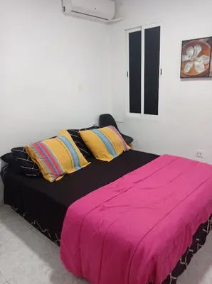 a bedroom with a large bed with a pink blanket at Valencia 2 en piso familiar compartido in Valencia