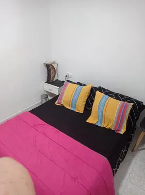 a bedroom with a bed with colorful sheets and pillows at Valencia 2 en piso familiar compartido in Valencia