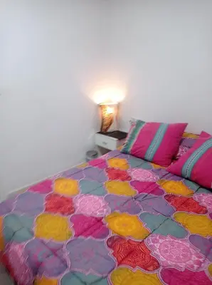 a bedroom with a bed with a colorful bedspread at Valencia 2 en piso familiar compartido in Valencia