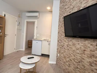 a living room with a flat screen tv on a brick wall at Apartment Ruzafa Market 8B in Valencia