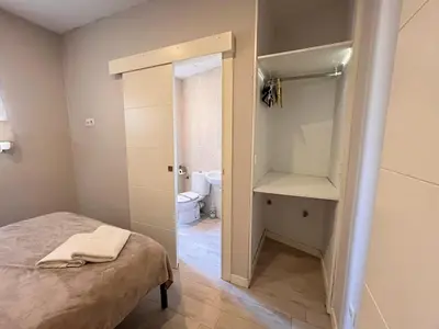 a bedroom with a bed and a bathroom with a toilet at Apartment Ruzafa Market 8B in Valencia