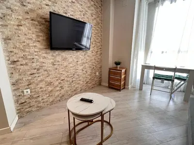 a living room with a tv on a brick wall at Apartment Ruzafa Market 8B in Valencia