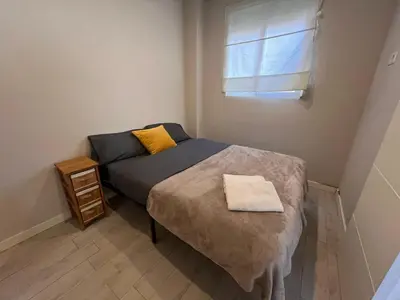 a small bedroom with a bed and a window at Apartment Ruzafa Market 8B in Valencia