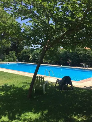 a person bending over next to a bench next to a pool at Ideal apartment in Náquera, Pool, Wifi in Náquera