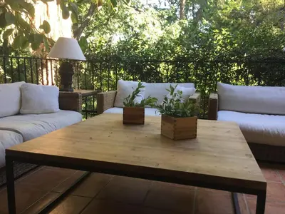 a wooden coffee table on a patio with two couches at Ideal apartment in Náquera, Pool, Wifi in Náquera