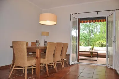 a dining room with a wooden table and chairs at Ideal apartment in Náquera, Pool, Wifi in Náquera